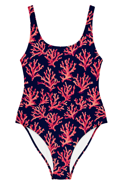A one-piece swimsuit with a navy blue background and an all-over coral print in shades of pink, red, and orange, shown against a plain white background.