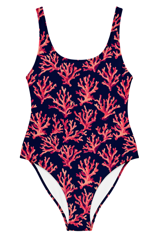A one-piece swimsuit with a navy blue background and an all-over coral print in shades of pink, red, and orange, shown against a plain white background.